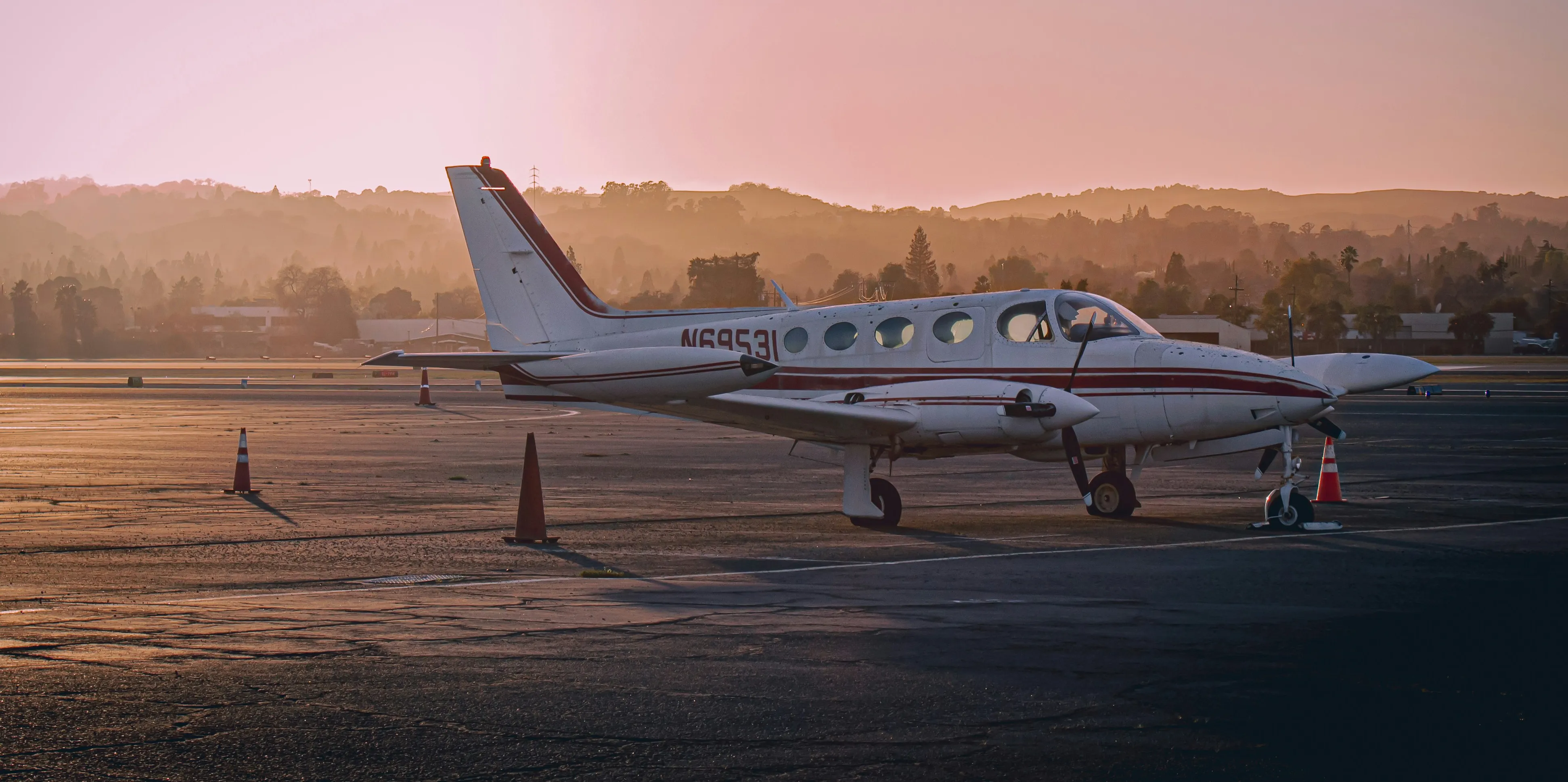 Small plane on runway at sunset